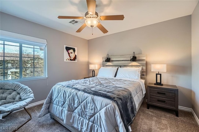 carpeted bedroom with visible vents, baseboards, and a ceiling fan