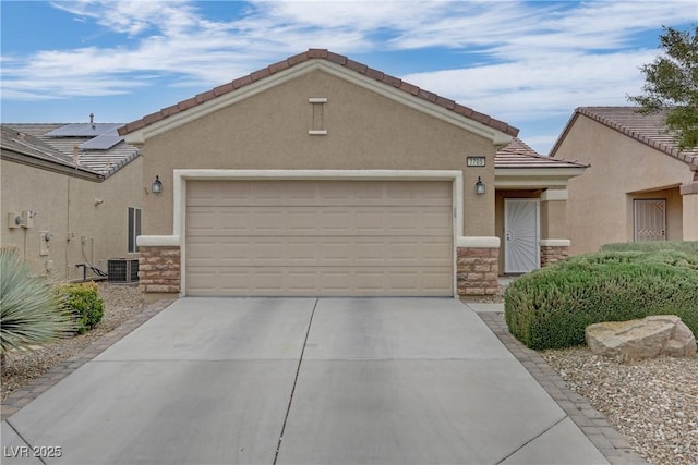 view of front of home with a tiled roof, stone siding, stucco siding, and an attached garage