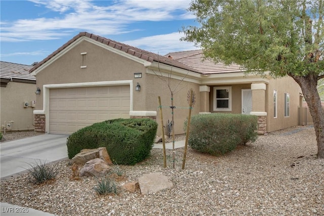 view of front of house featuring stucco siding, an attached garage, a tile roof, and concrete driveway