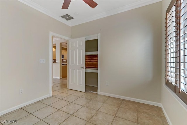 unfurnished bedroom with visible vents, crown molding, and baseboards