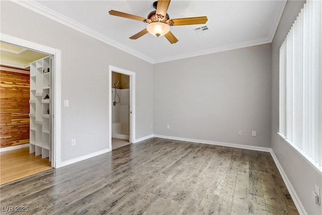 unfurnished bedroom featuring wood finished floors, visible vents, and ornamental molding