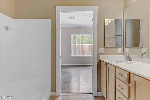 bathroom featuring vanity, tile patterned floors, baseboards, and visible vents