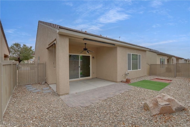 rear view of property featuring a patio area, a fenced backyard, stucco siding, and ceiling fan