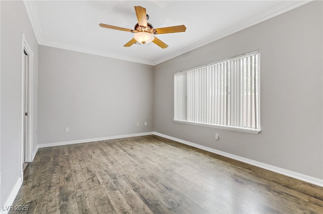 empty room with crown molding, wood finished floors, baseboards, and ceiling fan