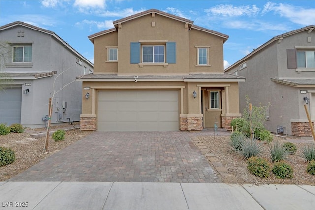 view of front of home featuring stone siding, stucco siding, decorative driveway, and a garage