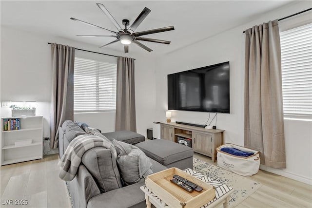 living room with light wood-type flooring and ceiling fan