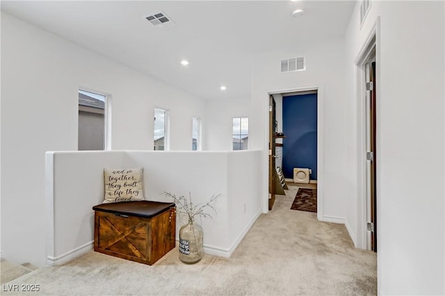 corridor with recessed lighting, visible vents, baseboards, and carpet