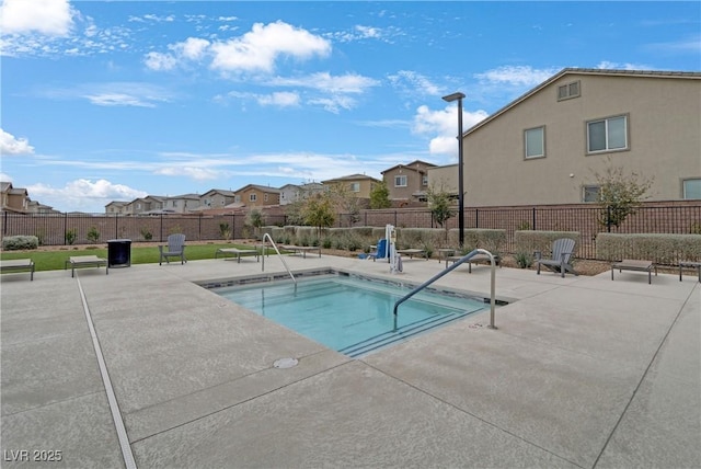 view of swimming pool with a residential view, a patio, a pool, and a fenced backyard