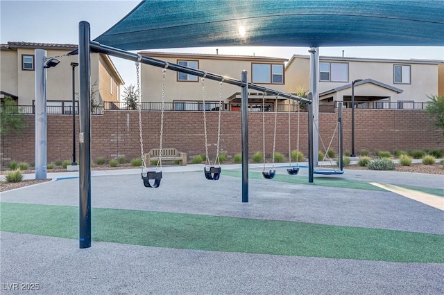 exterior space featuring playground community and fence