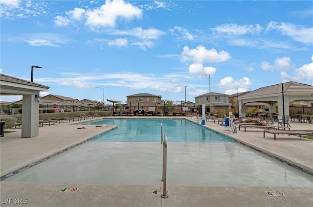 pool with a gazebo, a patio, and fence