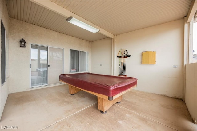 rec room with billiards and unfinished concrete flooring