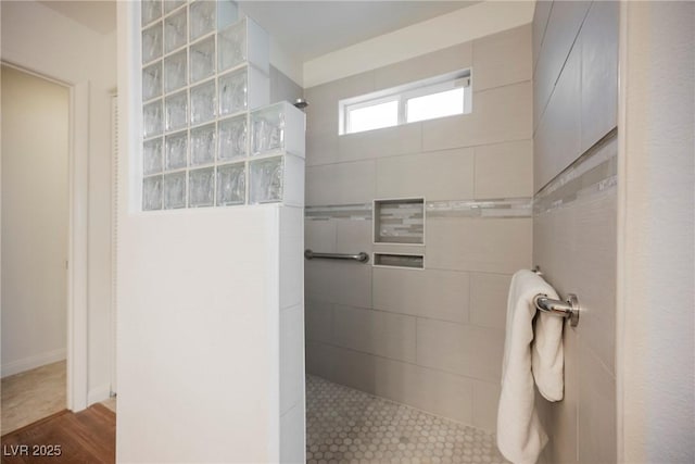 bathroom featuring walk in shower and wood finished floors