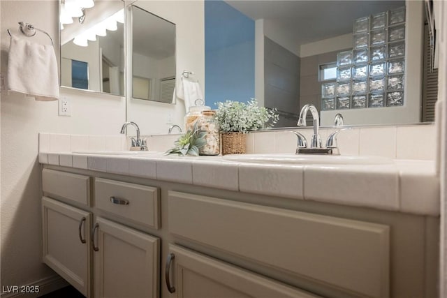 full bathroom with double vanity and a sink