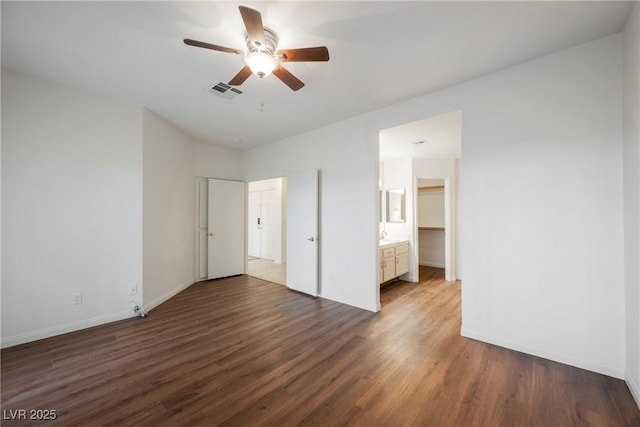 unfurnished bedroom with visible vents, baseboards, and wood finished floors