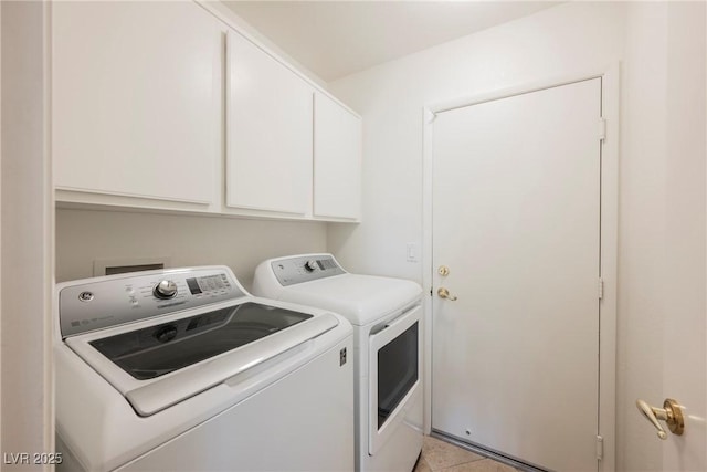 washroom with cabinet space and washing machine and dryer