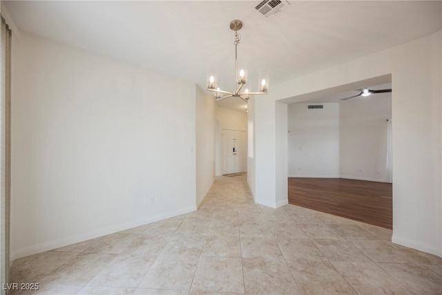 unfurnished room with light tile patterned flooring, visible vents, and baseboards