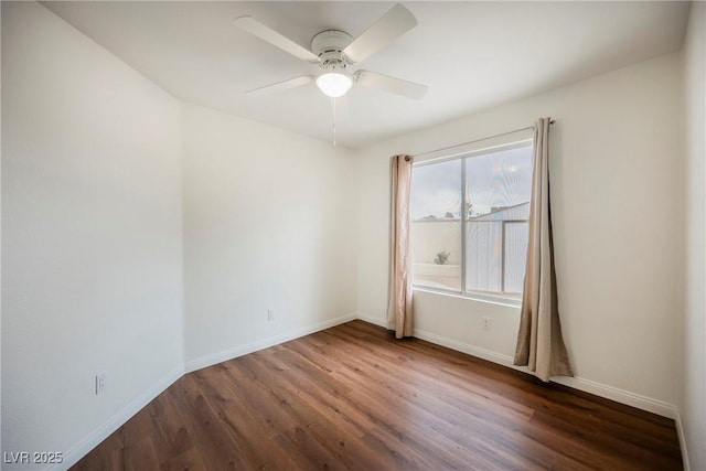 empty room with baseboards, ceiling fan, and wood finished floors