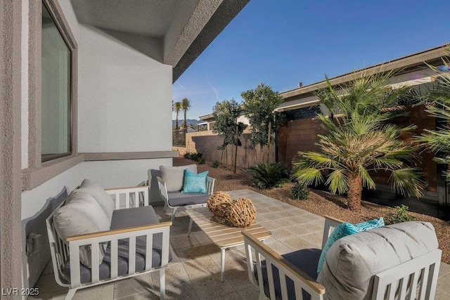 view of patio with an outdoor hangout area and fence