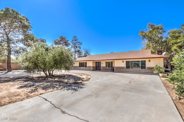 10615 Rancho Destino Rd, Las Vegas, NV 89183 - ranch-style house with stucco siding, brick siding, roof with shingles, and a chimney