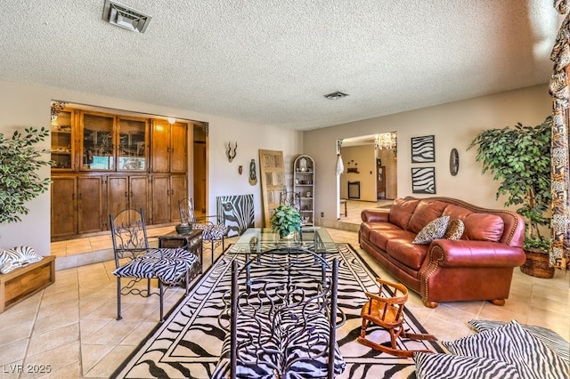 10615 Rancho Destino Rd, Las Vegas, NV 89183 - living area with light tile patterned flooring, visible vents, and a textured ceiling