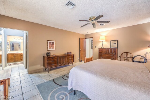 10615 Rancho Destino Rd, Las Vegas, NV 89183 - bedroom with light tile patterned floors, visible vents, a textured ceiling, and a ceiling fan