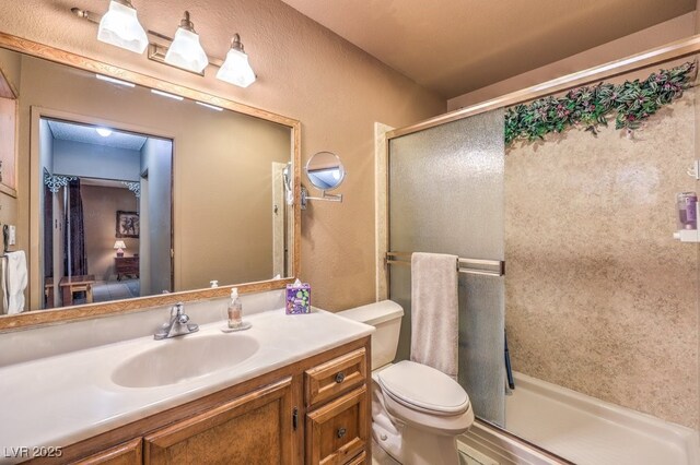 10615 Rancho Destino Rd, Las Vegas, NV 89183 - bathroom with vanity, toilet, a shower stall, and a textured wall