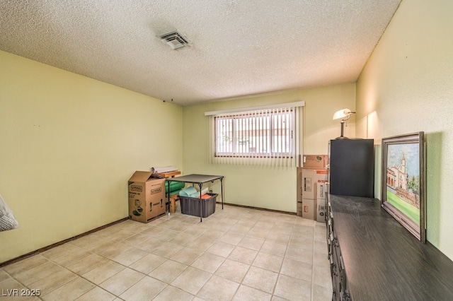 10615 Rancho Destino Rd, Las Vegas, NV 89183 - interior space featuring light tile patterned floors, visible vents, a textured ceiling, and baseboards