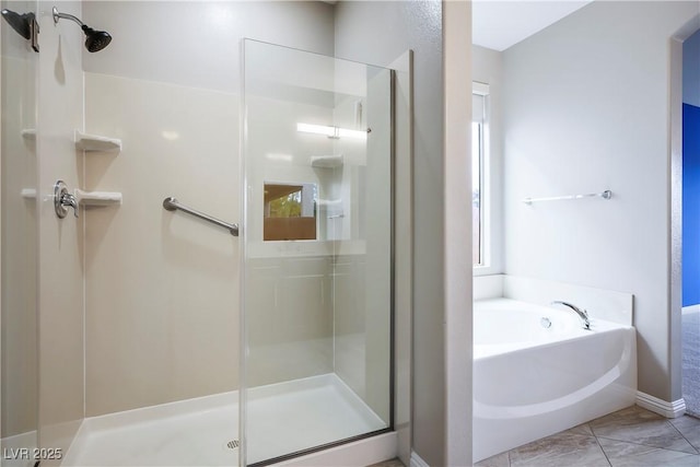 bathroom featuring a garden tub and a shower stall