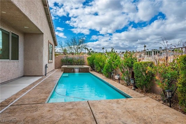 view of pool with a fenced backyard, an in ground hot tub, and a patio