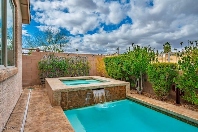 outdoor pool with an in ground hot tub and a fenced backyard