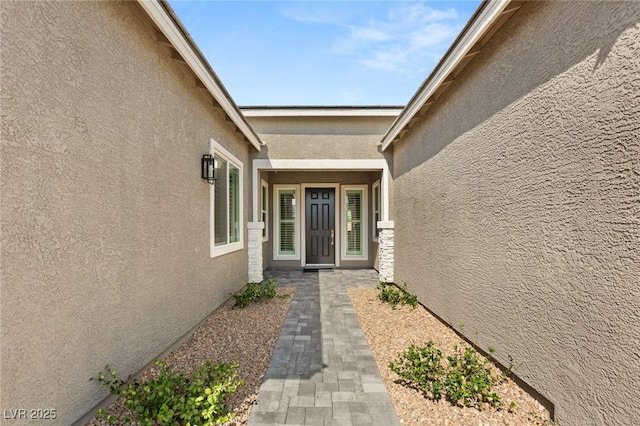 property entrance featuring stucco siding