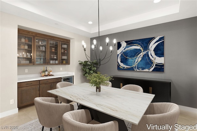 dining space featuring a raised ceiling, light tile patterned floors, recessed lighting, and baseboards