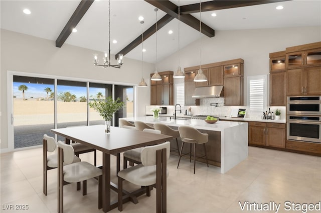 dining room featuring beam ceiling, a chandelier, recessed lighting, and high vaulted ceiling