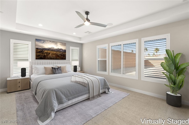 bedroom with visible vents, recessed lighting, baseboards, and a tray ceiling