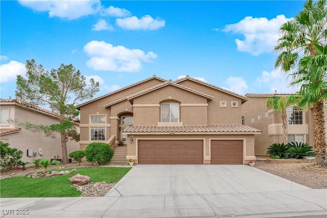 mediterranean / spanish home featuring stucco siding, driveway, a tile roof, and a garage