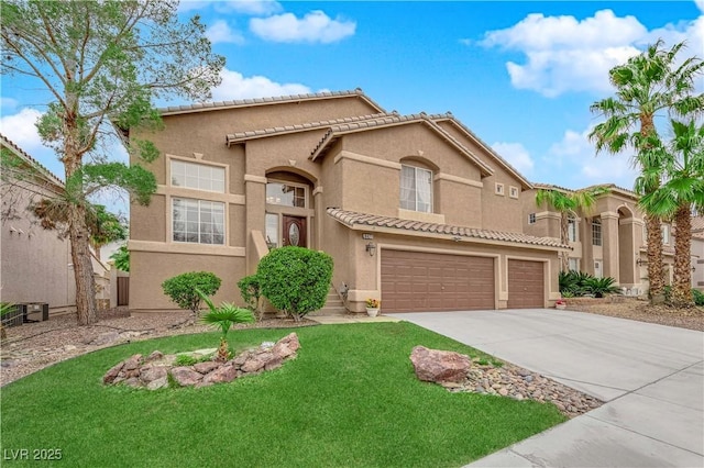 mediterranean / spanish home with a tiled roof, stucco siding, an attached garage, and driveway