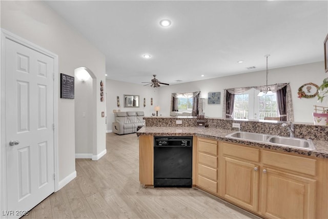 kitchen featuring light wood-style flooring, light brown cabinets, black dishwasher, and a sink