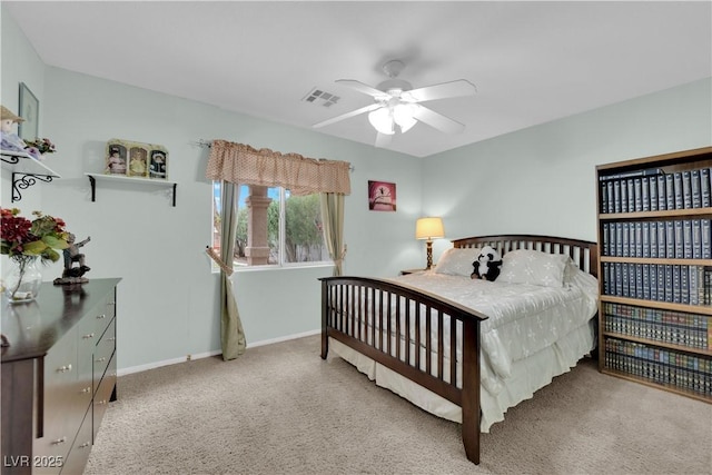 carpeted bedroom with a ceiling fan, baseboards, and visible vents