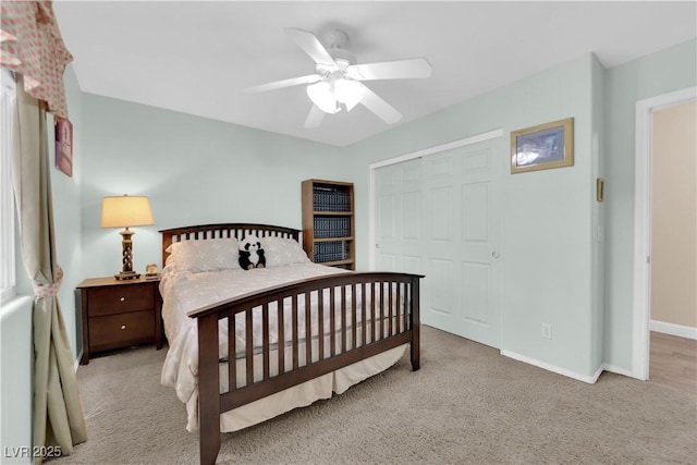 carpeted bedroom with a closet, a ceiling fan, and baseboards