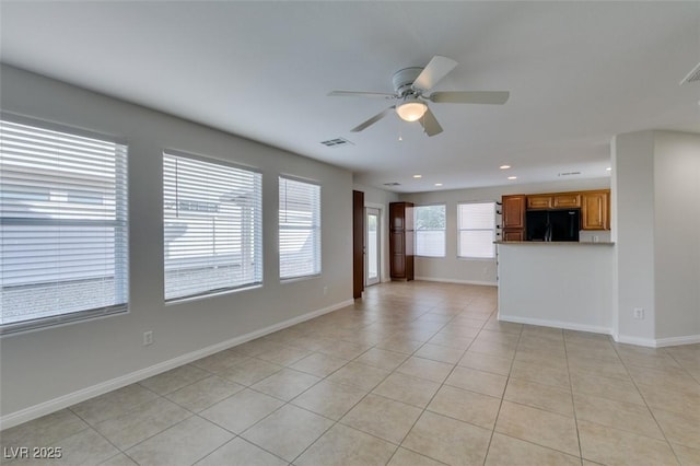 unfurnished living room featuring light tile patterned flooring, visible vents, baseboards, and ceiling fan