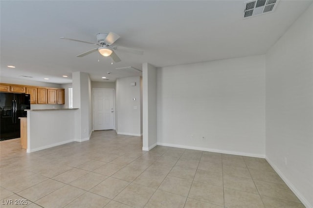 unfurnished living room featuring light tile patterned floors, baseboards, visible vents, and ceiling fan