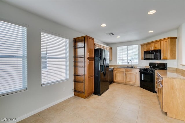 kitchen with black appliances, recessed lighting, visible vents, and a sink