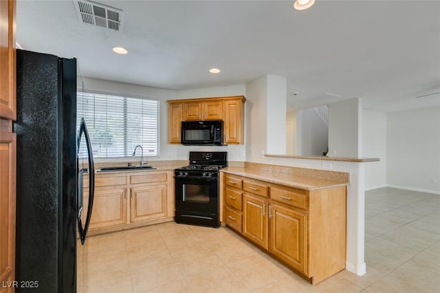 kitchen featuring visible vents, a peninsula, recessed lighting, a sink, and black appliances