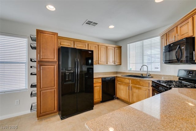 kitchen featuring visible vents, light tile patterned floors, recessed lighting, black appliances, and a sink