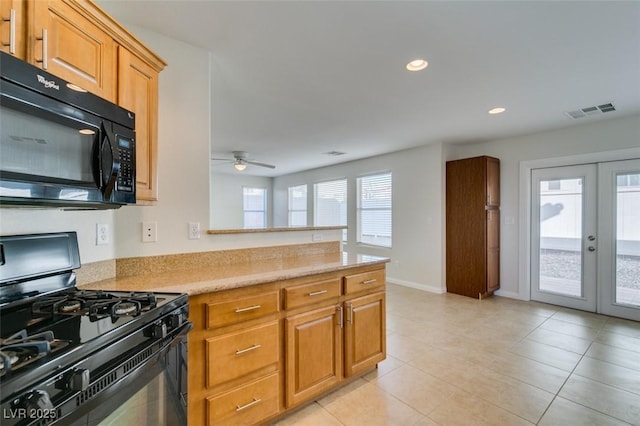 kitchen with visible vents, light countertops, a peninsula, black appliances, and a ceiling fan