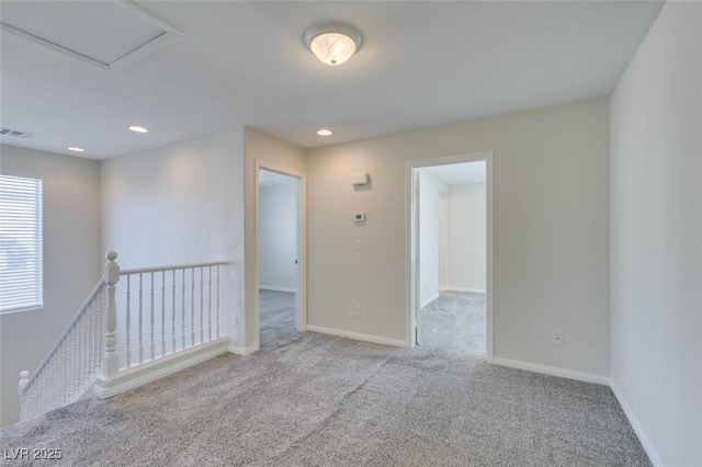 carpeted empty room featuring recessed lighting, visible vents, and baseboards