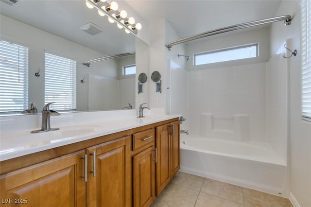 bathroom with a sink, shower / bathing tub combination, double vanity, and tile patterned floors