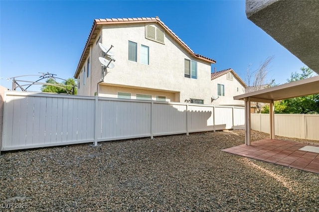 view of yard featuring a patio area and a fenced backyard