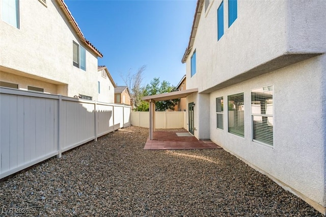 view of yard featuring a patio area and a fenced backyard