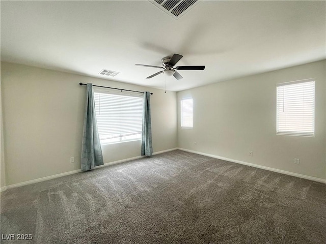 carpeted empty room with visible vents, baseboards, and a ceiling fan